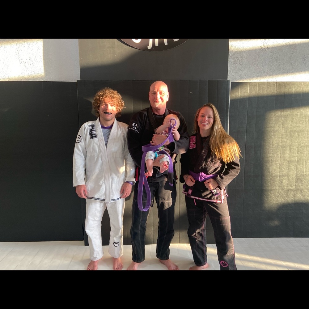 Black Submit everyone gi with pink letters.